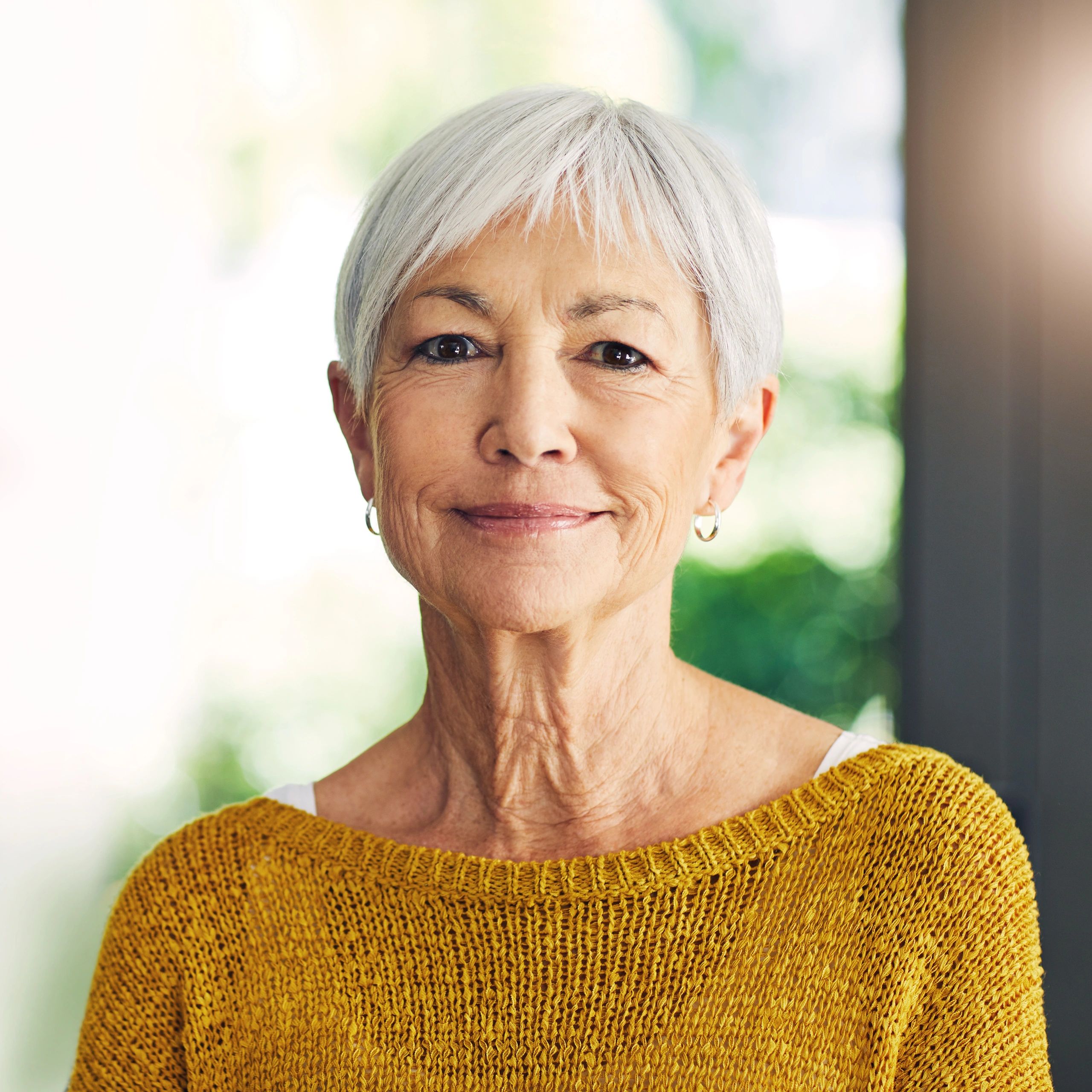 Confident senior woman smiling naturally at home