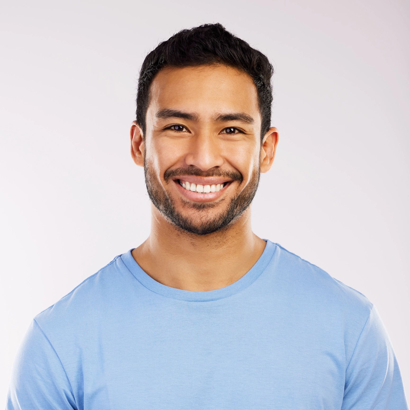 Happy man smiling in a clean portrait setting